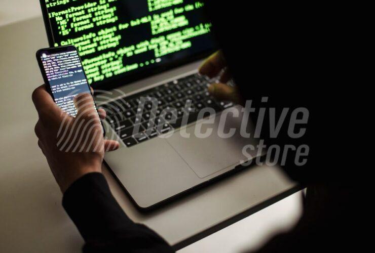 A forensic specialist analyzes digital data on a smartphone and laptop, showcasing advanced data recovery and cybersecurity investigation techniques.