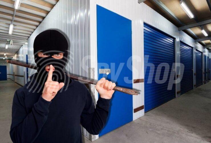 A masked burglar holding a crowbar inside a storage facility, symbolizing the risk of storage unit break-ins and the importance of security measures.