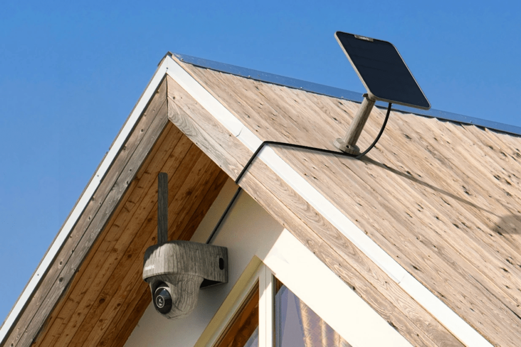 A solar-powered security camera mounted on a roof, offering a sustainable and efficient surveillance solution for home security.