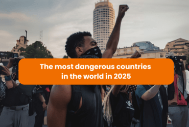 A protester raising a fist during a demonstration, symbolizing unrest, with a caption highlighting the most dangerous countries in 2025
