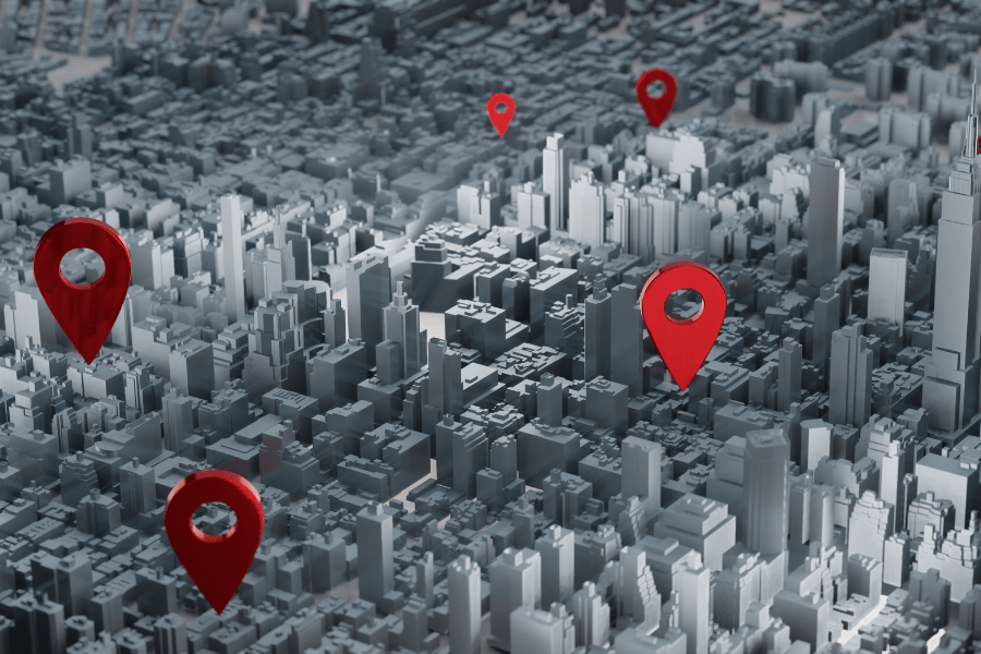 A three-dimensional map of the city with red pins marking GPS locations. Visualisation of monitoring and position tracking in a densely built-up urban area.